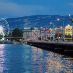 a pier with a ferris wheel and buildings by it